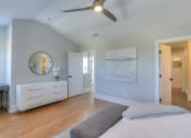 Thumbnail 1 of 23 - a bedroom with a bed and a ceiling fan
