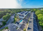 Thumbnail 4 of 23 - an aerial view of a building with a pool and parking lot