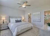 Thumbnail 7 of 14 - a bedroom with a bed and a ceiling fan