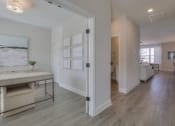 Thumbnail 12 of 14 - a view of a kitchen and living room from a hallway