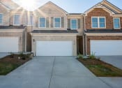 Thumbnail 1 of 30 - a white garage door in front of a brick house