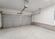 Thumbnail 27 of 30 - the interior of a garage with a white wall and a garage door