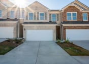 Thumbnail 1 of 50 - Exterior view of townhomes with a 2 car garage