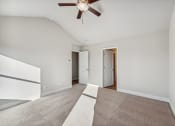 Thumbnail 41 of 50 - Primary bedroom with carpet and ceiling fan.