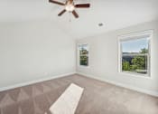 Thumbnail 34 of 50 - Primary bedroom with carpet and ceiling fan.