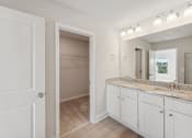 Thumbnail 33 of 50 - primary bathroom with double vanity and large walk-in closet.