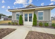 Thumbnail 40 of 51 - an exterior view of a home with a walkway and a driveway