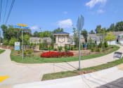 Thumbnail 2 of 50 - a street sign in front of a yard with flowers