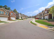 Thumbnail 49 of 50 - a street with rows of houses on either side