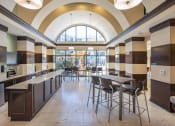 Thumbnail 16 of 38 - Clubhouse Cafe with seating area. Granite counter top area holds kitchen sink at The Bartram Apartments in Gainesville, FL 32608