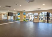 Thumbnail 27 of 38 - 2nd floor of Fitness Center with wall to wall mirror and WellBeats virtual trainer. Exercise balls and yoga mats available at The Bartram Apartments in Gainesville, FL 32608