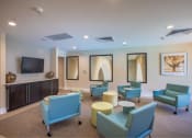 Thumbnail 20 of 38 - 5 rolling desk chairs seating area facing TV located in the 2nd story of the Clubhouse at The Bartram Apartments in Gainesville, FL 32608
