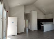 Thumbnail 13 of 30 - an empty room with white walls and a fireplace
