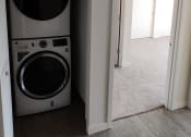 Thumbnail 10 of 30 - a front loading washer and dryer in a laundry room