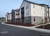 Thumbnail 1 of 30 - an empty street in front of an apartment building