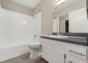 Thumbnail 12 of 15 - a bathroom with a toilet sink and bathtub