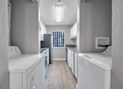 Thumbnail 38 of 43 - a white kitchen with white appliances and a wood floor