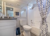 Thumbnail 13 of 22 - a bathroom with a shower and a toilet and a sink