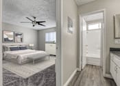 Thumbnail 4 of 44 - a bedroom and a bathroom with a ceiling fan