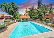 Thumbnail 3 of 15 - a swimming pool with a fence and a house with a pool
