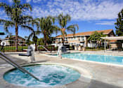 Thumbnail 1 of 29 - a swimming pool with trees and a building in the background