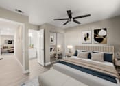 Thumbnail 9 of 29 - A bedroom with a large bed and a ceiling fan.