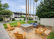 Thumbnail 1 of 16 - A backyard with a fire pit and chairs.