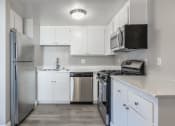 Thumbnail 3 of 22 - Kitchen with fridge and stovetop