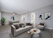 Thumbnail 3 of 20 - A living room with a grey couch and a coffee table.