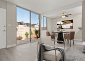 Thumbnail 4 of 15 - a living room with a sliding glass door leading to a patio