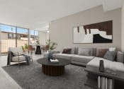 Thumbnail 5 of 15 - a living room with a couch and a table in front of a window