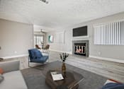 Thumbnail 4 of 21 - Living room with a fireplace and a television.