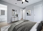 Thumbnail 10 of 21 - A bedroom with a bed, a ceiling fan, and two framed pictures on the wall.
