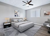 Thumbnail 8 of 21 - A bedroom with a large bed, a ceiling fan, and a chair.