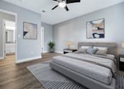 Thumbnail 9 of 21 - A bedroom with a large bed and a ceiling fan.