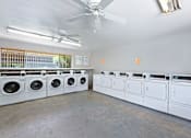 Thumbnail 15 of 15 - a laundry room with white washers and dryers