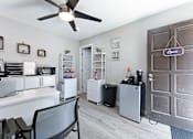 Thumbnail 10 of 15 - a room with a desk and a ceiling fan