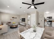 Thumbnail 8 of 29 - A modern living room with a marble table and a ceiling fan.
