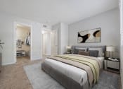 Thumbnail 9 of 20 - A bedroom with a large bed and a painting on the wall.