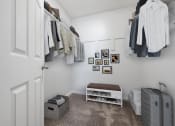 Thumbnail 7 of 20 - A small room with a bench and a suitcase.