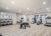 Thumbnail 4 of 35 - A spacious gym with a variety of exercise equipment.