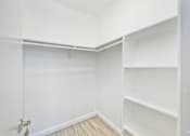 Thumbnail 41 of 42 - A white closet with shelves and a door.
