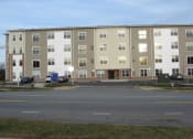 Thumbnail 5 of 6 - a tan and white building with many windows  at Rosewood Village, Hagerstown, Maryland