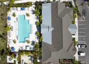 Thumbnail 15 of 29 - a birds eye view of a pool and a building with trees