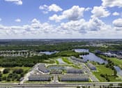 Thumbnail 29 of 29 - an aerial view of a campus with a body of water