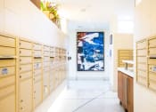 Thumbnail 23 of 28 - a long white hallway with wooden cabinets and a painting on the wall