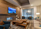 Thumbnail 24 of 31 - a living room with a couch and a table and a fireplace
