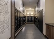 Thumbnail 18 of 31 - a long hallway with wine racks and a map on the wall