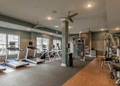Thumbnail 14 of 31 - a fitness center with treadmills and other exercise equipment in a building