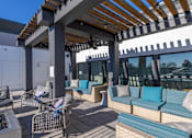 Thumbnail 26 of 31 - a patio with couches and chairs and a pergola